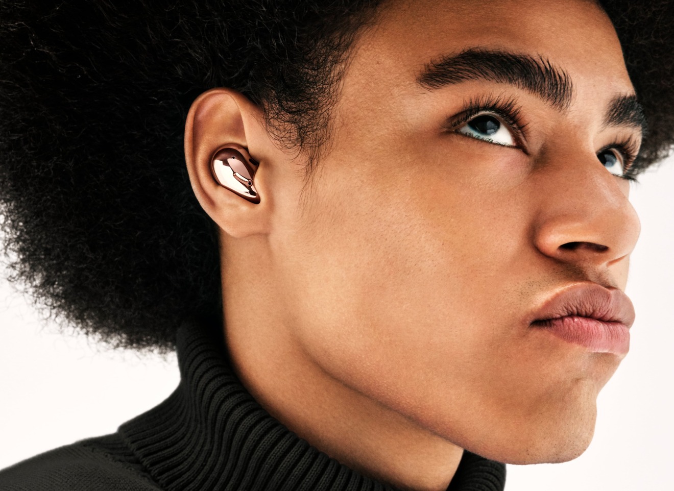 The Samsung Galaxy Buds Live are designed to sit within the ear's folds.
